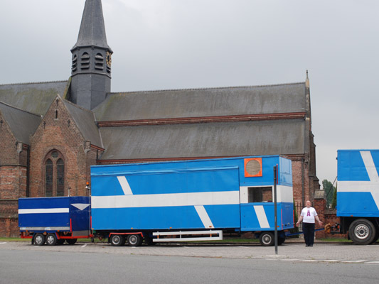 ''A' man between trucks & church', photographed by Marie-Thérèse Willemsen Antwerp - Schoten / Belgium